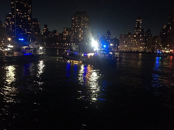 This image made from video provided by the New York City Police Department shows the scene of a helicopter crash in the East River in New York on Sunday, March 11, 2018. A Federal Aviation Administration spokeswoman said Sunday the Eurocopter AS350 went down just after 7 p.m. Sunday in the waterway just north of Roosevelt Island and is "reportedly inverted in the water." (New York City Police Department via AP)

