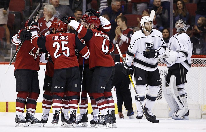 Arizona Coyotes center Nick Cousins (25) celebrates his goal with defenseman Niklas Hjalmarsson (4), center Brad Richardson, left, and others as Los Angeles Kings goaltender Jack Campbell (1) and defenseman Derek Forbort (24) look away during the first period Tuesday, March 13, 2018, in Glendale. (Ross D. Franklin/AP)
