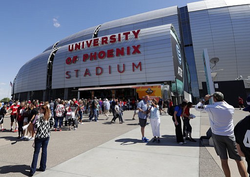 In this 2017 file photo, fans arrive at University of Phoenix Stadium before the semifinals of the Final Four NCAA college basketball tournament, Saturday, April 1, 2017, in Glendale, Ariz. A car-rental tax surcharge imposed in Maricopa County to pay for building sports and recreational facilities is legal, the Arizona Court of Appeals ruled Tuesday, March 13, 2018. (AP Photo/Matt York)
