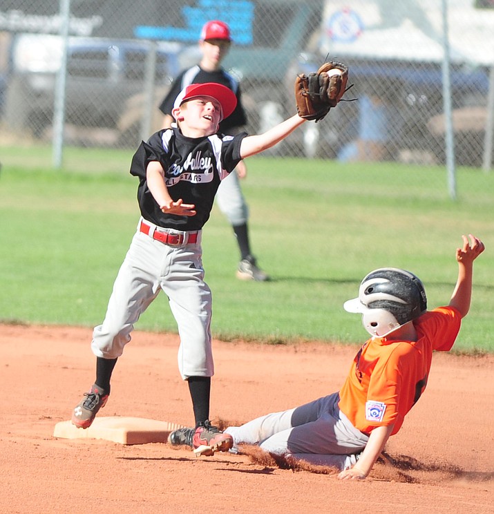 Prescott Valley’s Dylan Turk tries to tag out Williams’ Cody Jensen as the Prescott Valley All Stars play the Williams All Stars in the first round of the Little League District 10 Tournament in 2014. (Les Stukenberg/Courier, file)