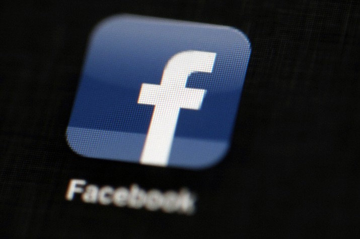 In this May 16, 2012, file photo, the Facebook logo is displayed on an iPad in Philadelphia. Facebook suspended Cambridge Analytica, a data-analysis firm that worked for President Donald Trump's 2016 campaign, over allegations that it held onto improperly obtained user data after telling Facebook it had deleted the information. (AP Photo/Matt Rourke, File)

