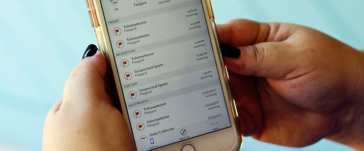 This Tuesday, Aug. 1, 2017, file photo, shows a call log displayed via an AT&T app on a cellphone in Orlando, Fla. The app helps locate and block fraudulent calls, although some robocalls do get through. A federal appeals court has rolled back rules intended to deter irritating telemarketing robocalls, saying they were too broad. (AP Photo/John Raoux, File)


