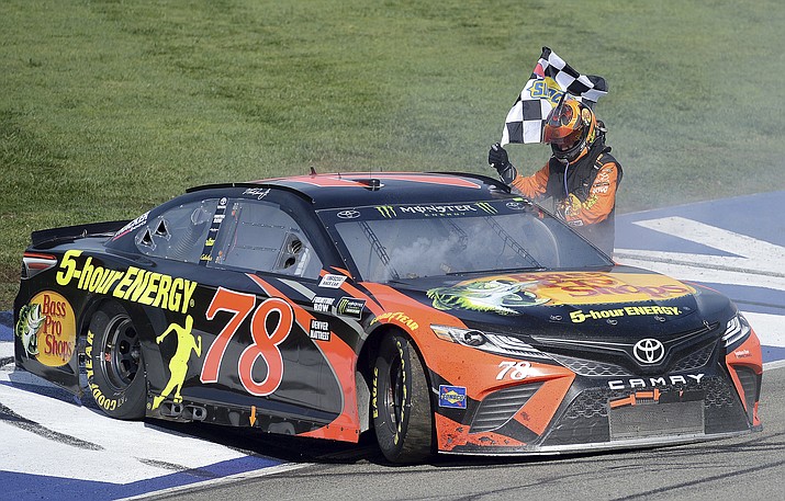 Martin Truex Jr. celebrates after winning the NASCAR 400 mile auto race Sunday, March 18, 2018, at Auto Club Speedway in Fontana, Calif . (Will Lester/AP)