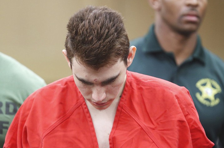 Nikolas Cruz is lead out of the courtroom after a March 14, 2018 arraignment hearing at the Broward County Courthouse in Fort Lauderdale, Fla. Cruz is accused of the shooting rampage that killed 14 students and three school employees at Marjory Stoneman Douglas High School in Parkland on Feb. 14. More than a year earlier, documents in the criminal case against Cruz school officials and a sheriff's deputy recommended in September 2016 that he be involuntarily committed for a mental evaluation. But the recommendation was never acted upon. (Amy Beth Bennett/South Florida Sun-Sentinel via AP, File)
