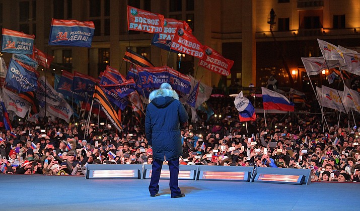 Russian President Vladimir Putin speaks to supporters during a rally near the Kremlin in Moscow, Sunday, March 18, 2018. Vladimir Putin headed to an overwhelming win in Russia's presidential election Sunday, adding six years in the Kremlin for the man who has led the world's largest country for all of the 21st century. (Alexei Druzhinin, Sputnik, Kremlin Pool Photo via AP)

