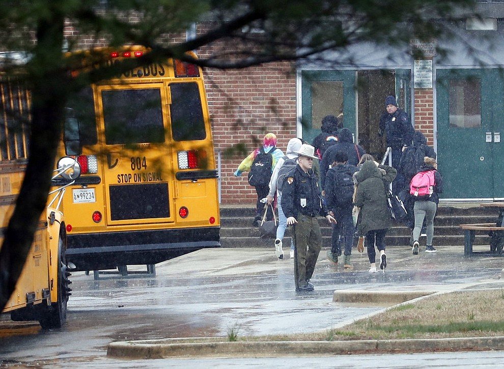 Police move students into a different area of Great Mills High School, the scene of a shooting, Tuesday morning, March 20, 2018 in Great Mills, Md.  (AP Photo/Alex Brandon  )