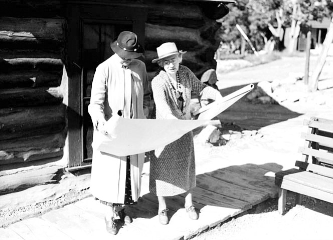 MARY COLTER (R) SHOWING BLUEPRINT TO MRS ICKES (WIFE OF SECRETARY OF INTERIOR) CIRCA 1935. NPS.