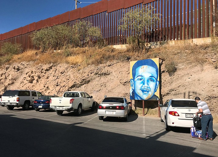 In this 2017 photo, a portrait of 16-year-old Mexican youth Jose Antonio Elena Rodriguez, who was shot and killed in Nogales, Sonora, Mexico, is displayed on the street where he was killed that runs parallel with the U.S. border. (Anita Snow/AP, File)