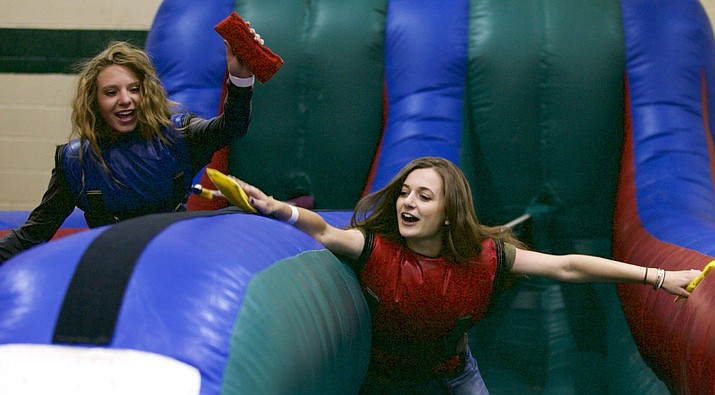 Former Prescott High School graduates Allie Jo Amos and Grace Doyle enjoy their time on a bouncy slide at the 2017 Grad Night Party on May 26, 2017, at the YMCA in Prescott. (Courtesy)