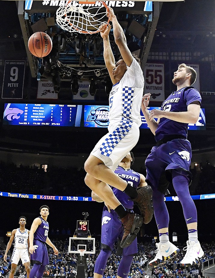 Kentucky forward Kevin Knox (5) dunks the ball against Kansas State forward Dean Wade (32) during the first half of a regional semifinal NCAA college basketball tournament game, Thursday, March 22, 2018, in Atlanta. (AP Photo/John Amis)