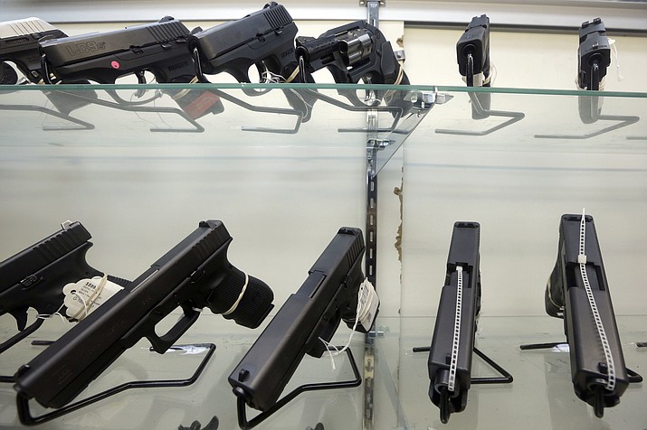 This June 29, 2016, file photo shows guns on display at a gun store in Miami. Support for tougher gun control laws is soaring in the United States, according to a new poll that found a majority of gun owners and half of Republicans favor new laws to address gun violence in the weeks after a Florida school shooting left 17 dead and sparked nationwide protests. (AP Photo/Alan Diaz, File)


