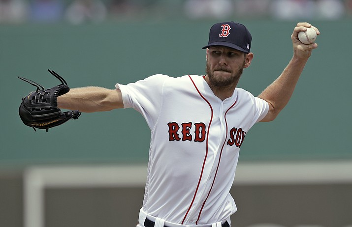 In this March 19, 2018, file photo, Boston Red Sox starting pitcher Chris Sale delivers to the Philadelphia Phillies during the first inning of a spring training baseball game in Fort Myers, Fla. Sale and and David Price were brought along slowly this spring, to keep them strong throughout the season. (Chris O'Meara/AP, File)