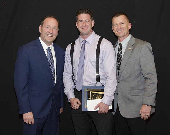 Police Officer of the Year Matt Hepperle is flanked by Police Chief Bryan Jarrell, left, and Deputy Chief James Edelstein. (Courtesy)