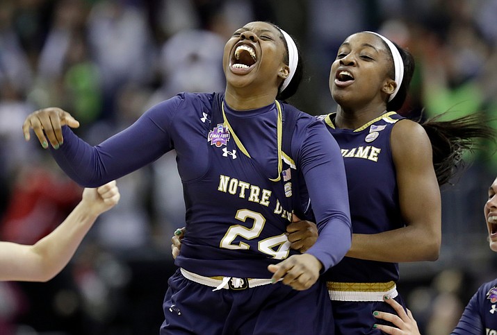 Notre Dame’s Arike Ogunbowale (24) is congratulated by teammate Jackie Young after sinking a 3-point basket to defeat Mississippi State 61-58 in the NCAA women’s championship Sunday, April 1, 2018, in Columbus, Ohio. (Tony Dejak/AP)