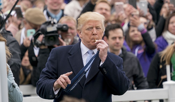 President Donald Trump blows a whistle to start a race for the annual White House Easter Egg Roll on the South Lawn of the White House on Monday, April 2, 2018, in Washington, D.C. (Andrew Harnik/AP)