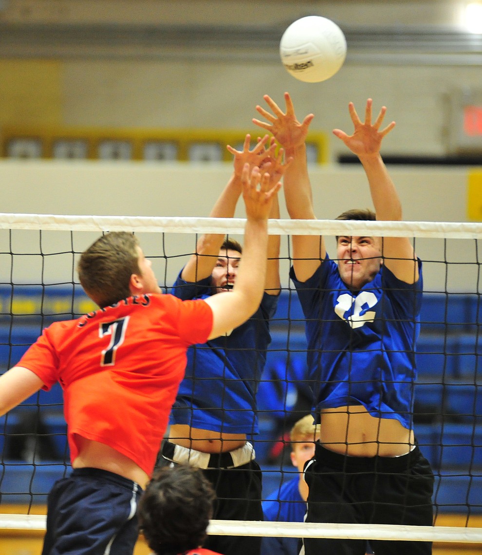 Prescott's Cole Fernandez and Paul Kinach go for a block as the Badgers hosted Centennial High School in a volleyball matchup Tuesday, April 3, 2018. (Les Stukenberg/Courier)