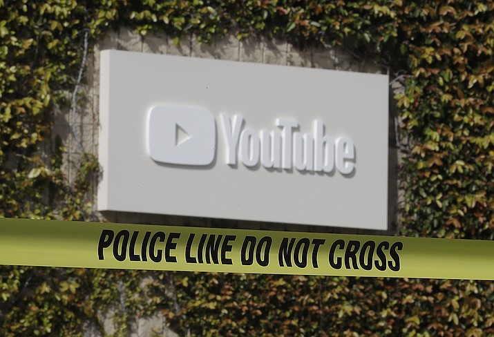 Police tape is shown outside of a YouTube office building in San Bruno, Calif., Wednesday, April 4, 2018. A woman suspected of shooting three people at YouTube headquarters before killing herself was furious with the company because it had stopped paying her for videos she posted on the platform, her father said Tuesday, April 3, 2018. (AP Photo/Jeff Chiu)

