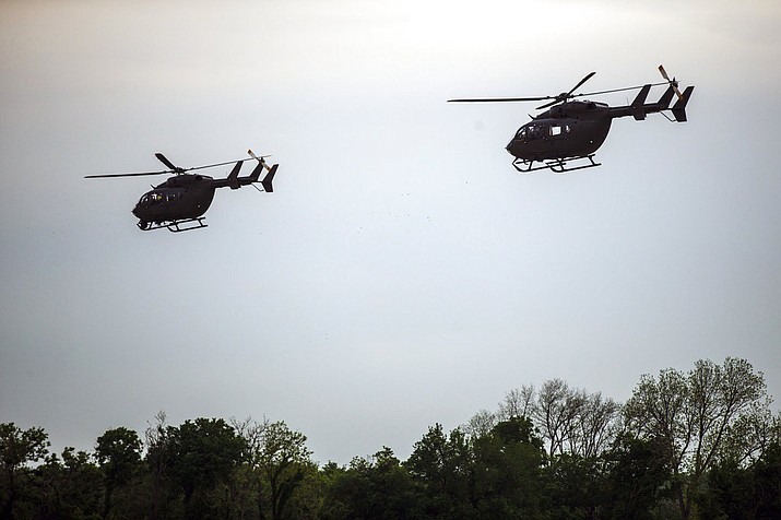 UH-72 Lakota helicopters take off from the Armed Forces Reserve Center at Austin-Bergstrom International Airport, Friday, April 6, 2018, in Austin, Texas. Their mission is part of an order signed by U.S. President Donald Trump earlier in the week, aimed at targeting drug trafficking and illegal immigration. (Amanda Voisard/Austin American-Statesman via AP)