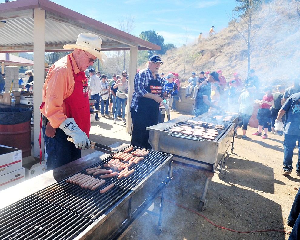 Members of the Rotary Club grill up burgers and hot dogs following opening ceremonies for the 2018 Prescott Little League Saturday, April 7, 2018 at Bill Vallely Field in Prescott. (Les Stukenberg/Courier)