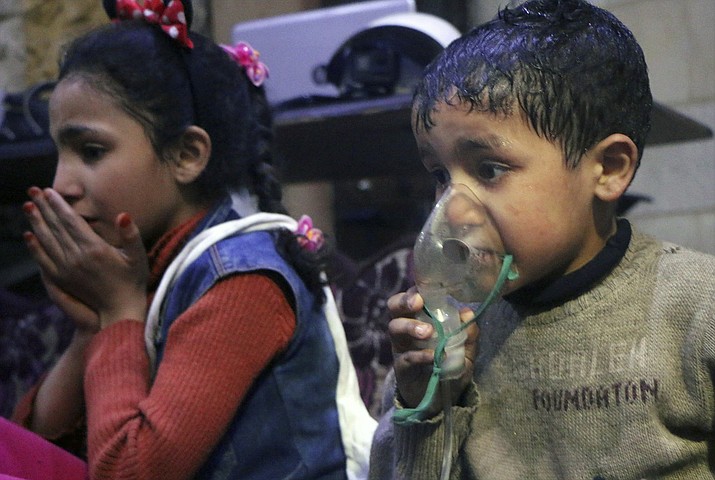 This image released early Sunday, April 8, 2018 by the Syrian Civil Defense White Helmets, shows a child receiving oxygen through respirators following an alleged poison gas attack in the rebel-held town of Douma, near Damascus, Syria. Syrian rescuers and medics said the attack on Douma killed at least 40 people. The Syrian government denied the allegations, which could not be independently verified. The alleged attack in Douma occurred Saturday night amid a resumed offensive by Syrian government forces after the collapse of a truce. (Syrian Civil Defense White Helmets via AP)

