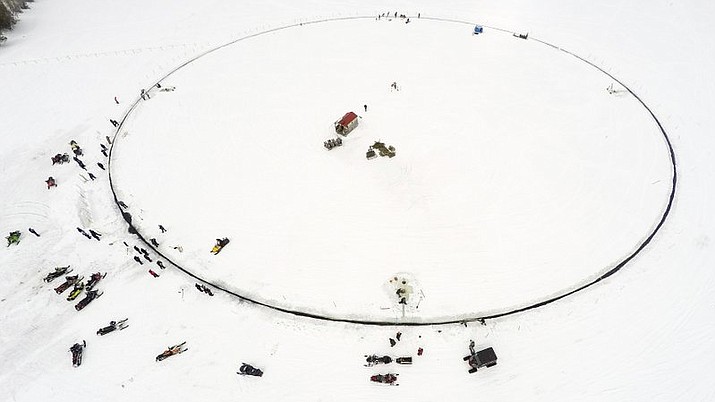 This photo provided by Paul Cyr shows a massive ice carousel that’s 427 feet in diameter on Saturday, April 7, 2018, on a frozen lake in Sinclair, Maine. Volunteers say it’s large enough to beat the old record held by a town in Finland; four outboard engines were used to make it rotate. (AP Photo/Paul Cyr)

