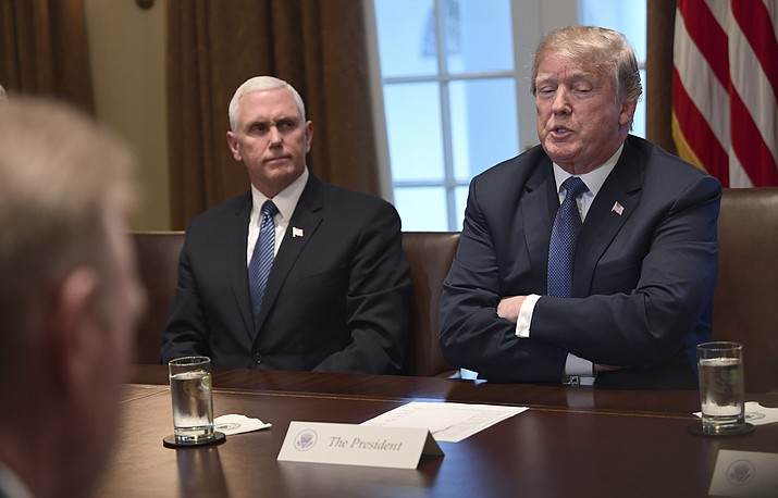 President Donald Trump, right, sitting next to Vice President Mike Pence, left, speaks in the Cabinet Room of the White House in Washington, Monday, April 9, 2018, at the start of a meeting with military leaders. (AP Photo/Susan Walsh)

