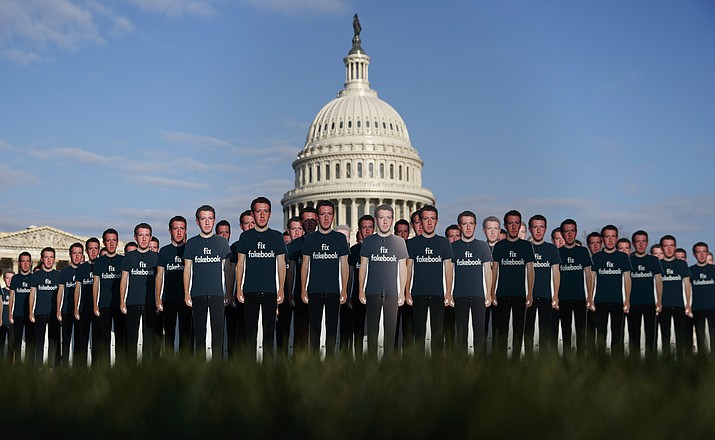 Life-sized cutouts depicting Facebook CEO Mark Zuckerberg wearing "Fix Fakebook" T-shirts are displayed by advocacy group, Avaaz, on the South East Lawn of the Capitol on Capitol Hill in Washington, Tuesday, April 10, 2018, ahead of Zuckerberg's appearance before a Senate Judiciary and Commerce Committees joint hearing. (AP Photo/Carolyn Kaster)

