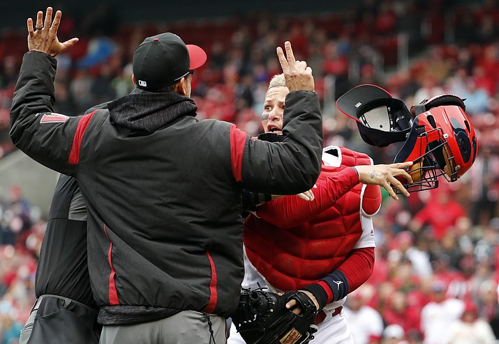 St. Louis Cardinals catcher Yadier Molina, right, throws off his mask as he argues with Arizona Diamondbacks manager Torey Lovullo during an altercation in the second inning of a baseball game Sunday, April 8, 2018, in St. Louis. (Jeff Roberson/AP)