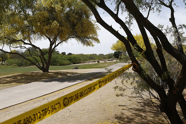 Police tape cordon off an area near the site of a plane crash that killed several people Tuesday, in Scottsdale. (Ross D. Franklin/AP)