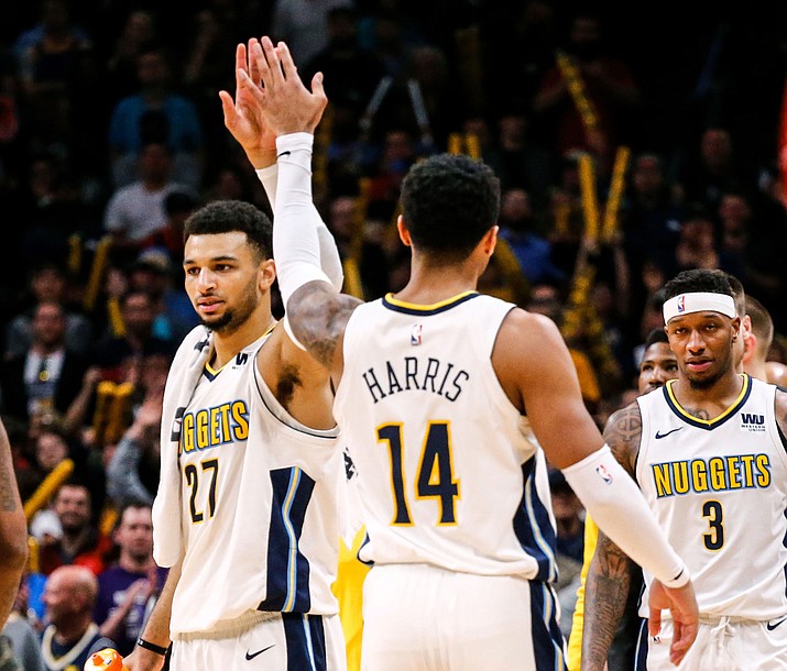 Denver Nuggets guard Jamal Murray (27) high-fives Gary Harris (14) in the final minute of play against the Portland Trail Blazers during the fourth quarter of an NBA basketball game, Monday, April 9, 2018, in Denver. Denver beat Portland 88-82. (Jack Dempsey/AP)