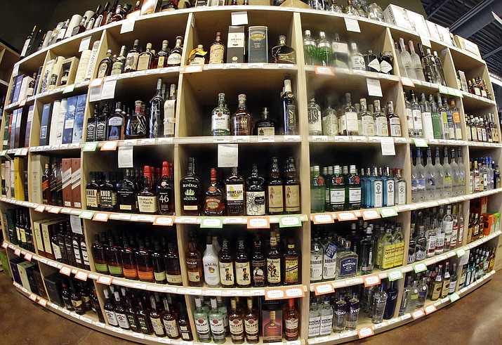 This June 16, 2016 file photo made with a fisheye lens shows bottles of alcohol during a tour of a state liquor store in Salt Lake City. A large international study released on Thursday, April 12, 2018 says adults should average no more than one alcoholic drink per day, and that means many countries’ alcohol consumption guidelines may be far too loose. (AP Photo/Rick Bowmer, File)


