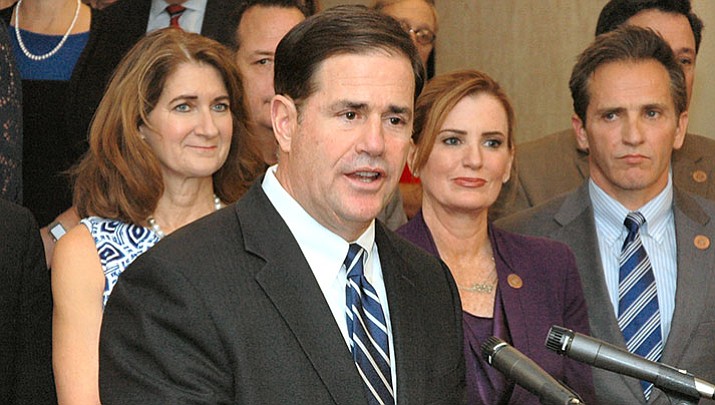 Flanked by Republican lawmakers, Gov. Doug Ducey unveils his plan Thursday to boost teacher pay by 20 percent by the beginning of the 2020-2021 school year. 