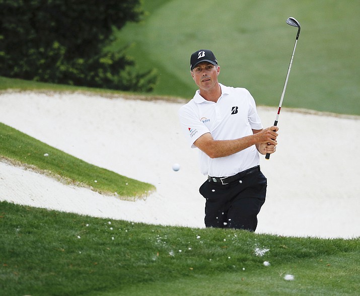 Matt Kuchar hits from a bunker on the 10th hole during the third round at the Masters golf tournament Saturday, April 7, 2018, in Augusta, Ga. Kuchar, along with Billy Horschel, Chesson Hadley and John Huh, shot 66 Thursday at the Heritage. (AP Photo/Charlie Riedel)