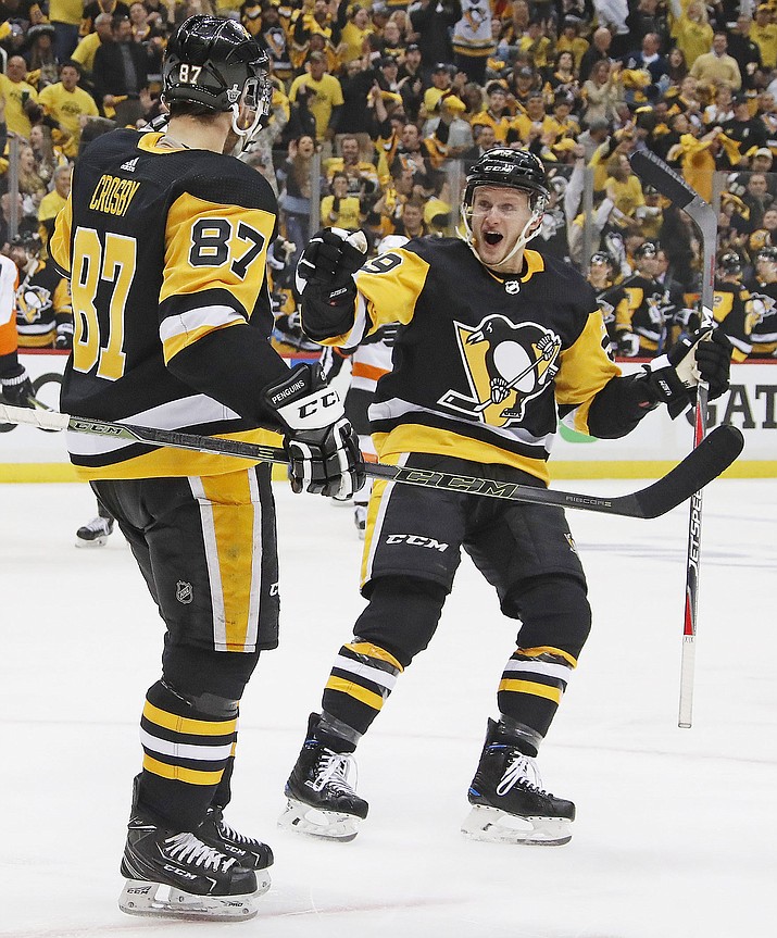 Pittsburgh Penguins' Sidney Crosby (87) celebrates his goal with Jake Guentzel (59) during the second period in Game 1 of an NHL first-round hockey playoff series against the Philadelphia Flyers in Pittsburgh, Wednesday, April 11, 2018. (AP Photo/Gene J. Puskar)