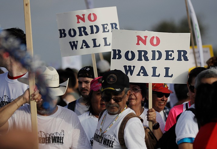 In this 2017 file photo hundreds of people march along a levee toward the Rio Grande to oppose the wall the U.S. government wants to build on the river separating Texas and Mexico, in Mission, Texas. (Eric Gay/AP, File)