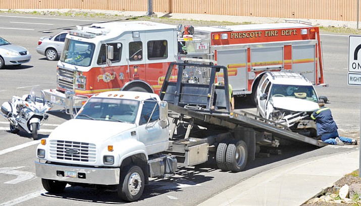 A tow truck driver loads an SUV that was involved in a wreck. Prescott Valley Police Department started looking into the practices of local towing companies after an incident was brought to their attention. Since then the department has changed its policies to help citizens. (File Photo/Courier)