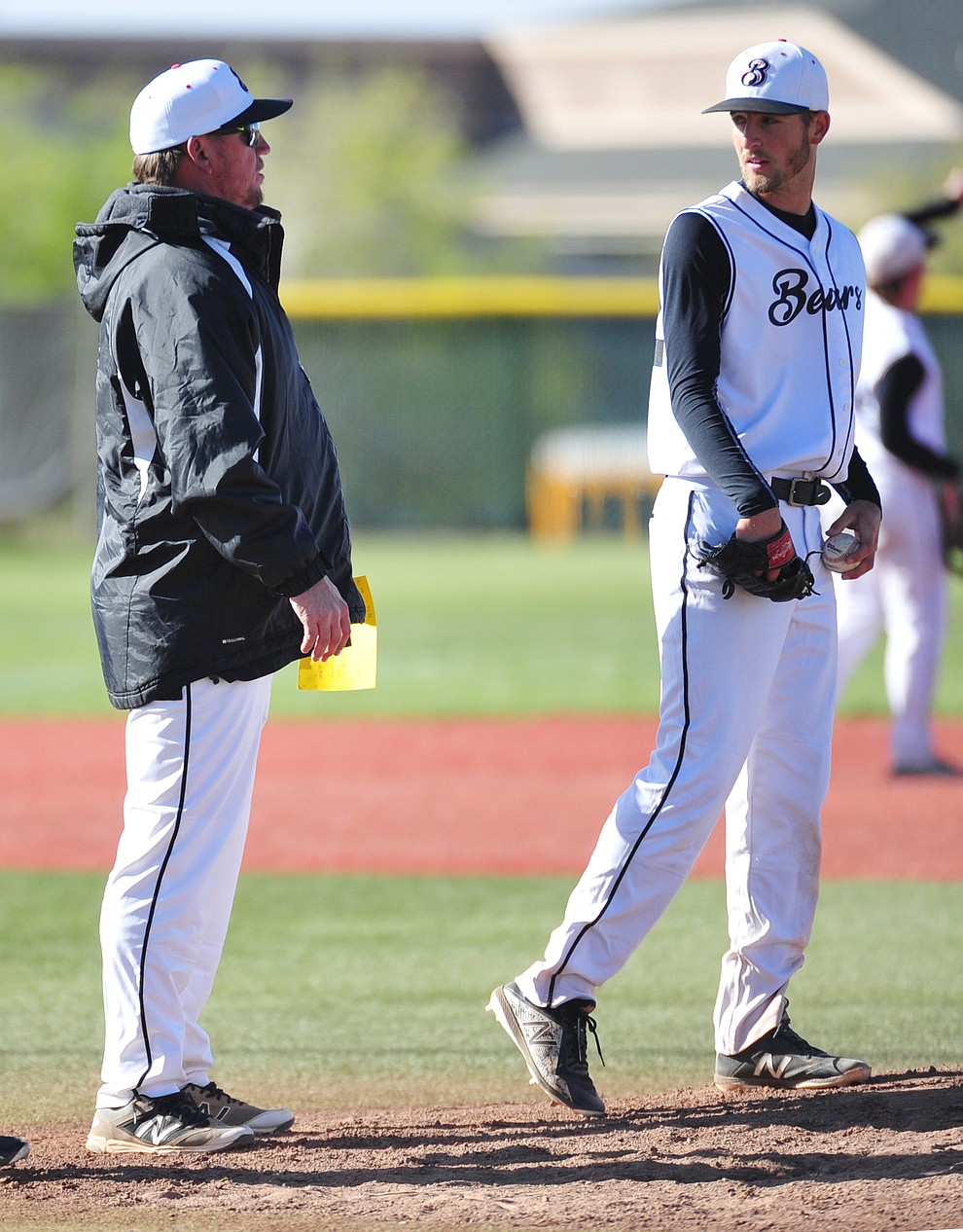 Bradshaw Mountain Head Coach Brian Bundrick talks to pitcher Paxton Prentice as the Bears hosted Shadow Mountain on a windy day in Prescott Valley Thursday, April 19, 2018. (Les Stukenberg/Courier)