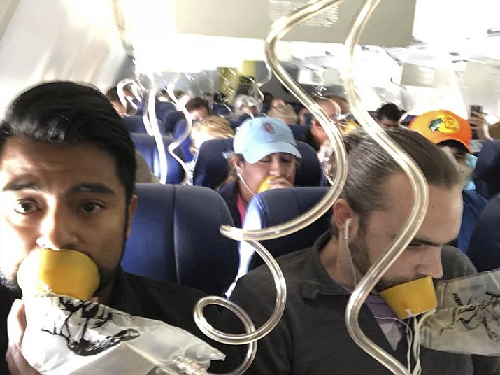 In this April 17, 2018 photo provided by Marty Martinez, Martinez, left, appears with other passengers after a jet engine blew out on the Southwest Airlines Boeing 737 plane he was flying in from New York to Dallas, resulting in the death of a woman who was nearly sucked from a window during the flight with 149 people aboard. A preliminary examination of the blown jet engine that set off a terrifying chain of events showed evidence of “metal fatigue,” according to the National Transportation Safety Board. (Marty Martinez via AP)

