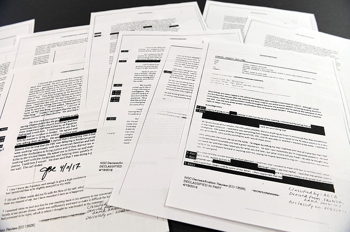Copies of the memos written by former FBI Director James Comey are photographed in Washington, Thursday, April 19, 2018. President Donald Trump told former FBI Director James Comey that he had serious concerns about the judgment of his first national security adviser, Michael Flynn, according to memos maintained by Comey and obtained by The Associated Press. The 15 pages of documents contain new details about a series of interactions that Comey had with Trump in the weeks before his May 2017 firing. Those encounters include a White House dinner at which Comey says Trump asked him for his loyalty. (AP Photo/Susan Walsh)

