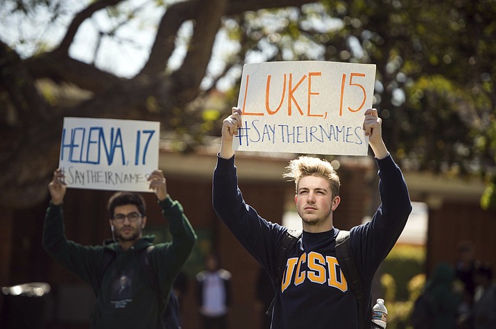 From left, Sevag Halajian, 18, and Christopher Meany, 17, hold names of those killed in mass school shootings as hundreds of students gather at Cleveland Charter High School in Los Angeles' Reseda neighborhood Friday, April 20, 2018. Students all over the country streamed out of their schools on the 19th anniversary of the Columbine High School shootings in the latest round of gun-control activism following the February shooting at a high school in Parkland, Fla. (Sarah Reingewirtz/Los Angeles Daily News via AP)

