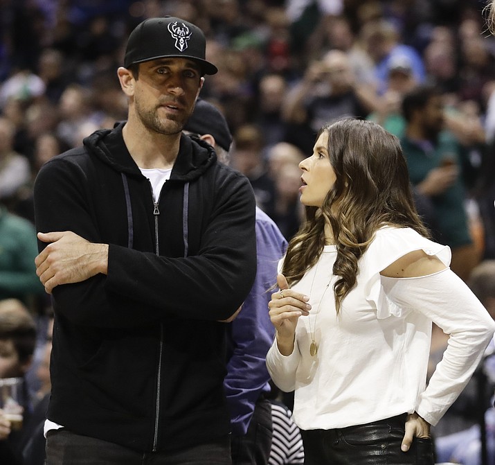 Danica Patrick talks to Green Bay Packers' Aaron Rodgers during the first half of Game 3 of an NBA basketball first-round playoff series between the Milwaukee Bucks and the Boston Celtics Friday, April 20, 2018, in Milwaukee. (Morry Gash/AP)