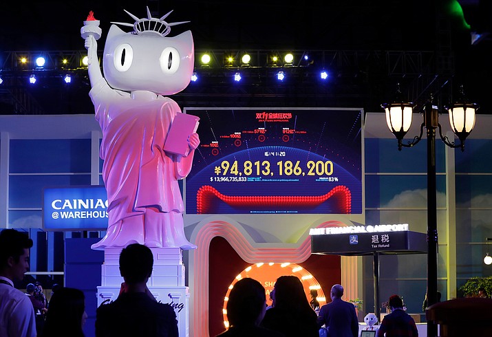 In this Nov. 11, 2016, file photo, a screen showing a total sales transacted of e-commerce giant Alibaba, on the "Singles' Day" global online shopping festival in Shenzhen, southern China's Guangdong province. Executives tell AP their companies were punished by Alibaba after they refused to enter exclusive partnerships with the Chinese e-commerce giant. Traffic to their Tmall storefronts fell, hurting sales, as they fought for fair access to a $610 billion Chinese online marketplace. Alibaba says it offers perks for exclusivity but has never punished anyone.(AP Photo/Kin Cheung, File)

