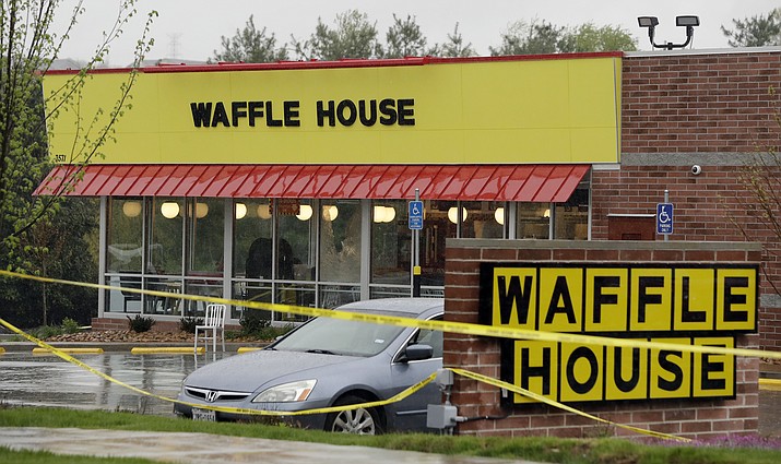 Police tape blocks off a Waffle House restaurant Sunday, April 22, 2018, in Nashville, Tenn. At least four people died after a gunman opened fire at the restaurant early Sunday.(AP Photo/Mark Humphrey)

