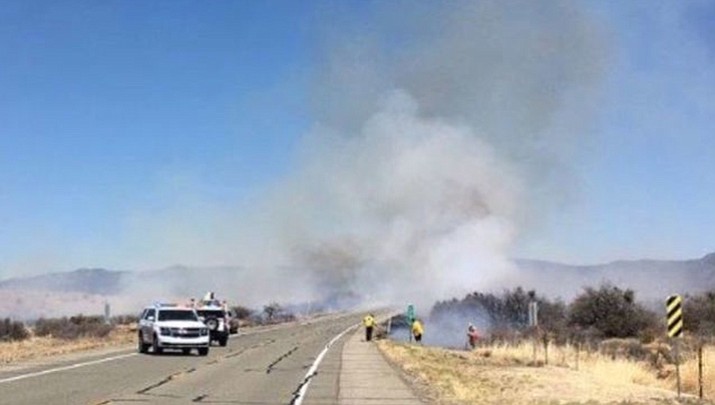 Authorities evacuated residents of Valle, Arizona Monday because of a wildfire started with someone burning debris. Valle is on state land about 35 miles north of Williams. One vacant structure has burned and others are threatened. (ADOT photo)