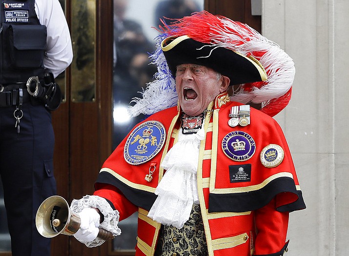 Town Crier Tony Appleton announces that the Duchess of Cambridge has given birth to a baby boy outside the Lindo wing at St Mary's Hospital in London London, Monday, April 23, 2018. Kensington Palace says the Duchess of Cambridge has given birth to her third child, a boy weighing 8 pounds, 7 ounces (3.8 kilograms). (AP Photo/Kirsty Wigglesworth)