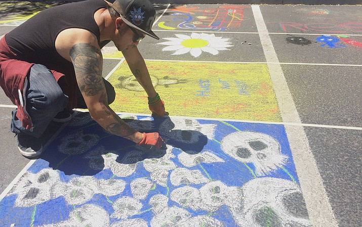 Russell Brown creates a chalk drawing at Chalk it Up in the National Bank of Arizona parking lot in Prescott Saturday, April 21. (Jason Wheeler/Courier)