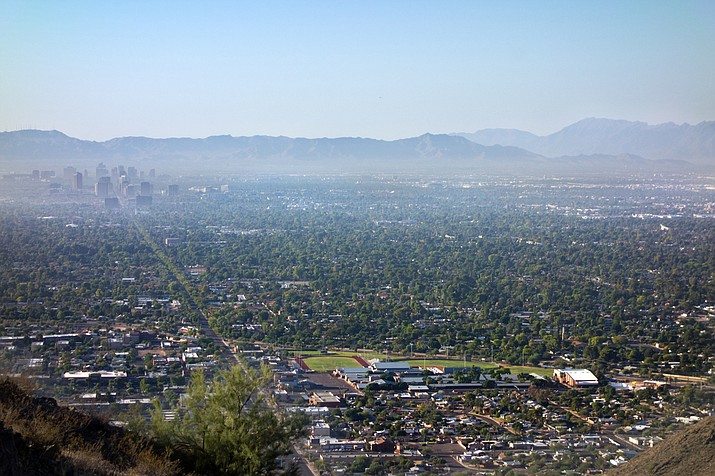 Pictured is air pollution from Interstate-10 and I-17 in the morning haze above the area of downtown Phoenix as seen from the top of North Mountain Park hiking trails. (File photo)