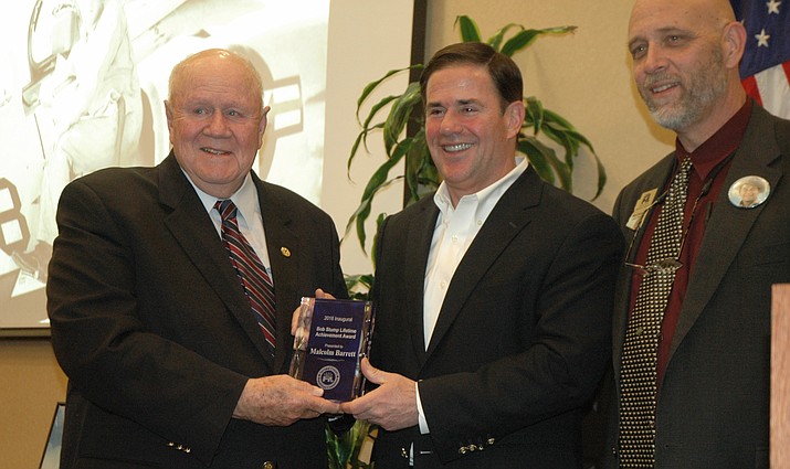 Former Yavapai County Republican Committee chairman Malcolm Barrett, left, received the inaugural Bob Stump Lifetime Achievement Award, presented by Gov. Doug Ducey, middle, and Yavapai County Republican Committee Chairman, Dr. Mark Sensmeier, at the 2018 Lincoln-Reagan Dinner, Saturday, April 21, at the Prescott Resort and Conference Center. (Jason Wheeler/Courier)