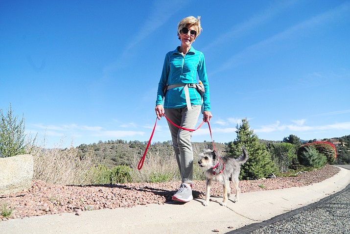 Jan Anderson walks her dog Maggie in her Prescott neighborhood Wednesday, April 18, 2018. Anderson and her dog have been attacked twice in her neighborhood and once on a local trail by dogs, whose owners did not control them according to Anderson. (Les Stukenberg/Courier)