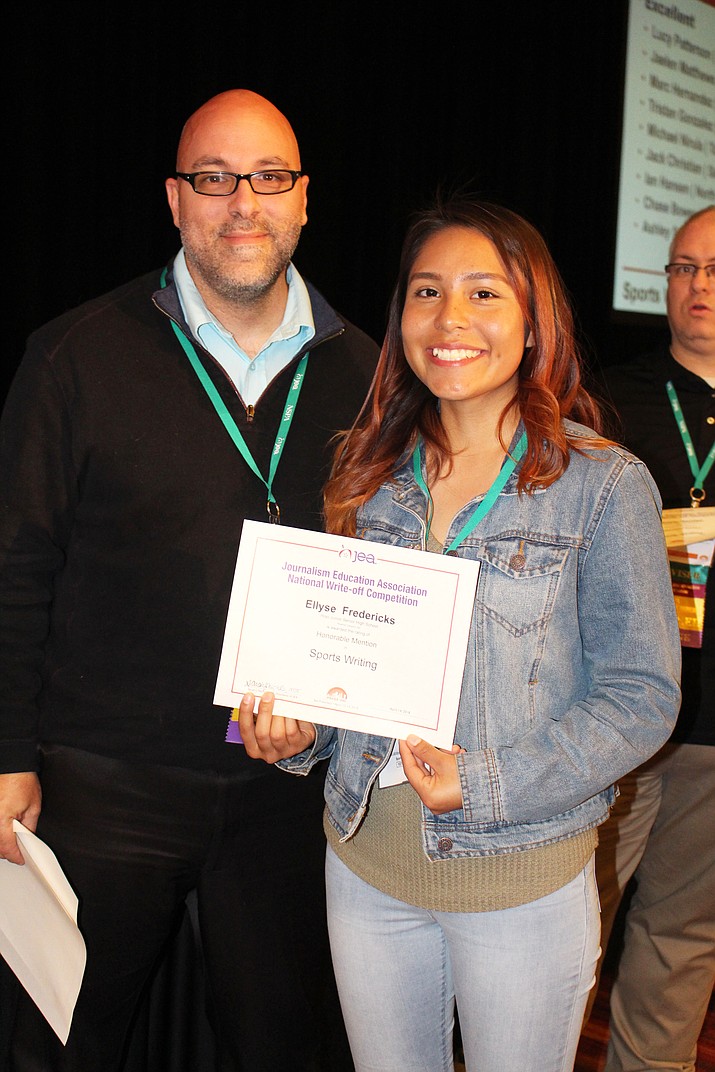 Hopi High print journalism student Ellyse Fredericks receives her national award from a Journalism Education Association official. (Stan Bindell/NHO)